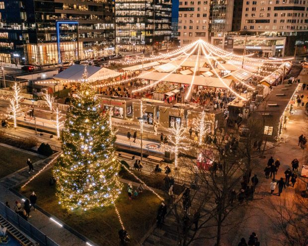 BIRDS-EYE VIEW OF BOSTON SEAPORT LIT UP AT CHRISTMAS TIME WITH CHRISTMAS TREE AND LIGHTS EVERYWHERE