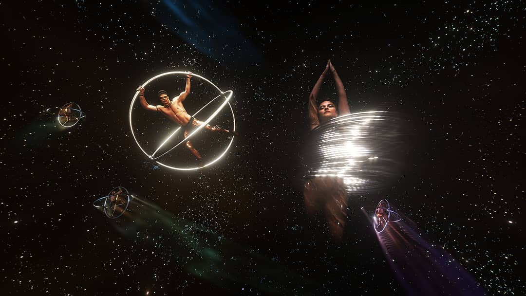 INDIVIDUALS IN SPACE TWIRLING AROUND IN METAL RINGS DURING CIRQUE DU SOLEIL PERFORMANCE, ALEGRIA