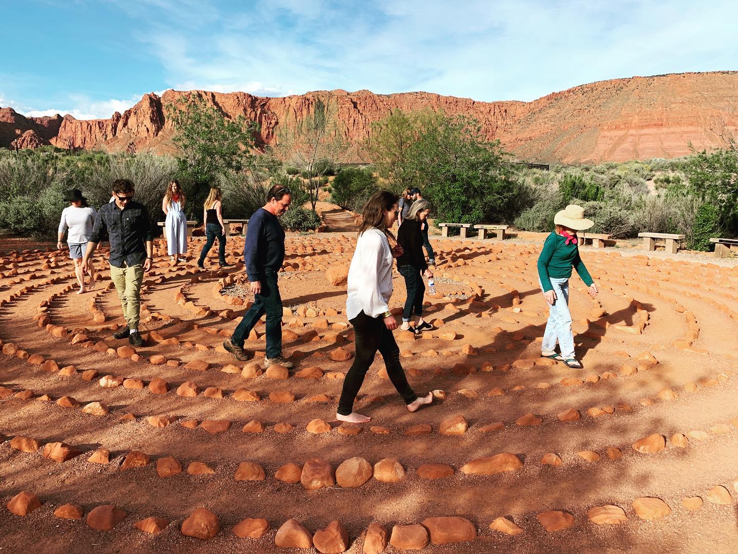 PEOPLE WALKING IN CIRCLES AROUND ROCK PATH AT NOMADIC SCHOOL OF WONDER RETREAT