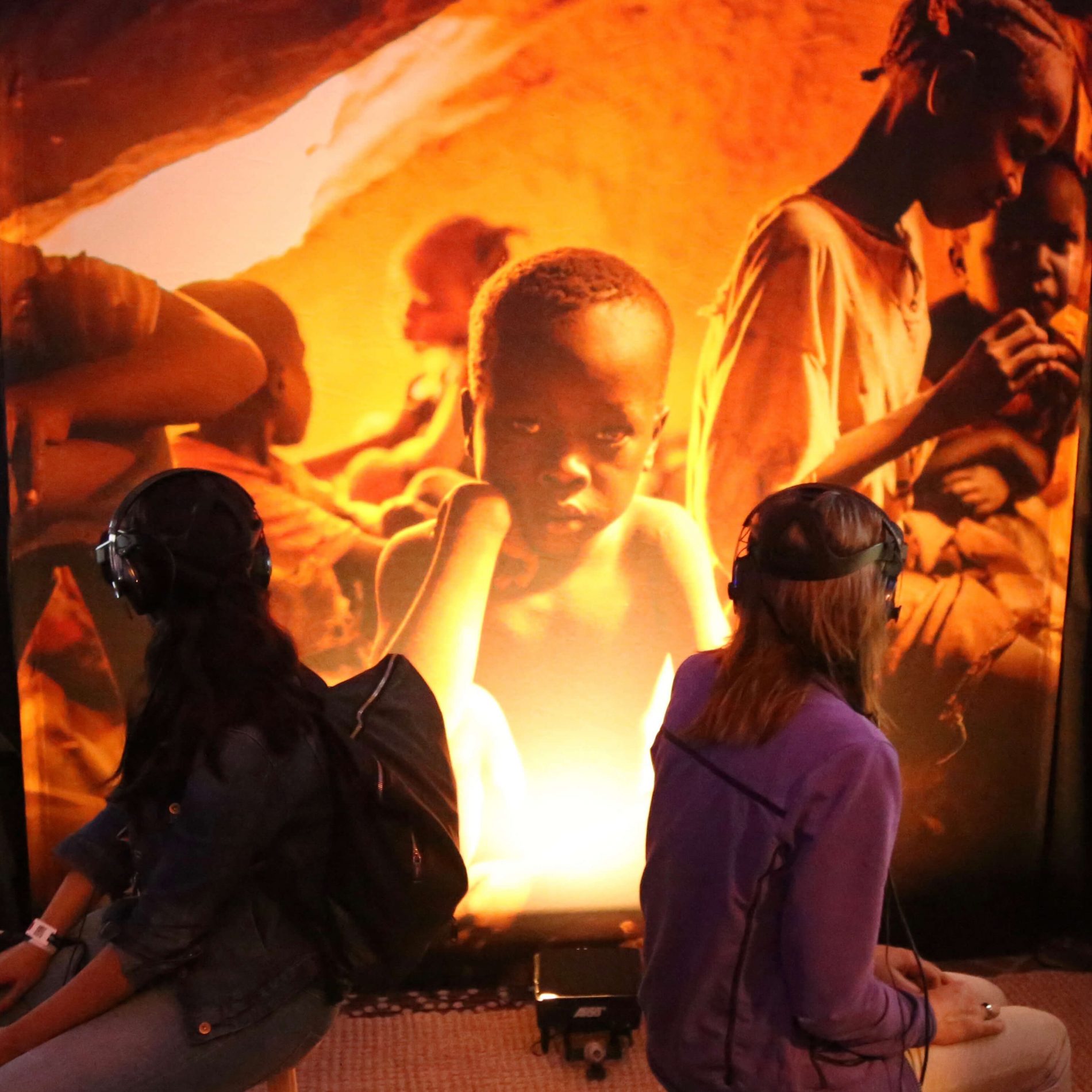 PEOPLE WITH HEADSETS STARE UP AT VR FILM SHOT OF ACTIVE CONFLICT ZONE IN WE WHO REMAIN