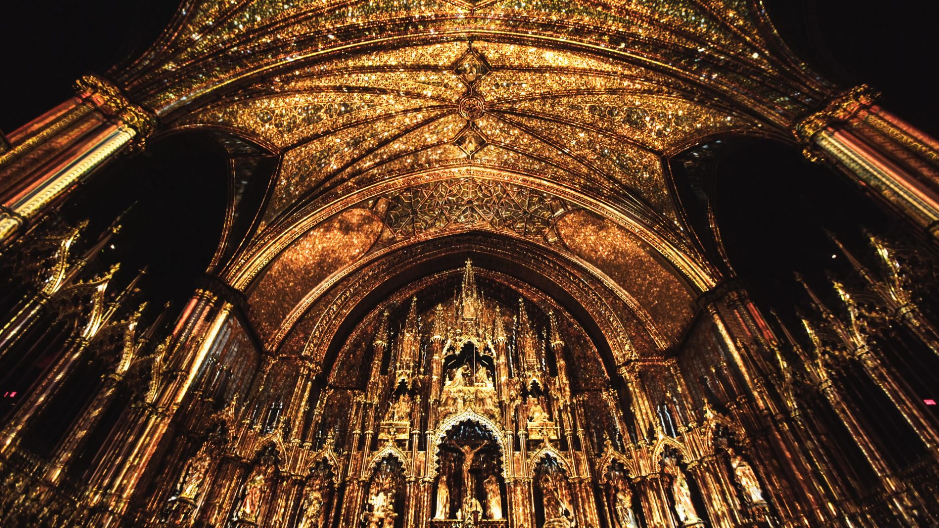 GOLDEN INTERIOR OF THE NOTRE DAME BASILICA IN MONTREAL FOR MOMENT FACTORY’S AURA AT THE NOTRE DAME BASILLICA