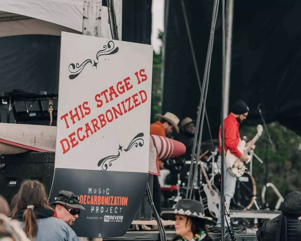SIGN AT STAGE THAT READS “THIS STAGE IS DECARBONIZED” FOR REVERB’S MUSIC DECARBONIZATION PROJECT